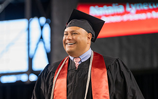 Graduate smiling while standing on stage