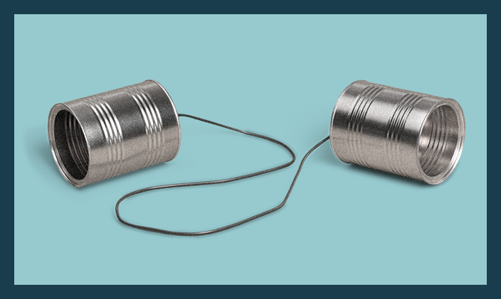 Two tin cans linked by a string to fashion a childhood telephone to signify communication specialist