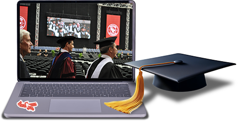 laptop computer with graduation cap sitting next to it