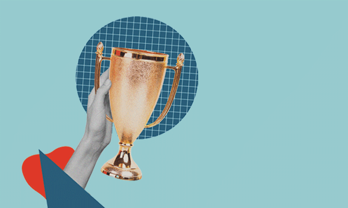 Hand extended holding a gold trophy in the center of the frame.