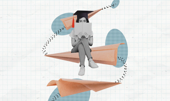 Woman sitting cross-legged with an open book and wearing a mortarboard.