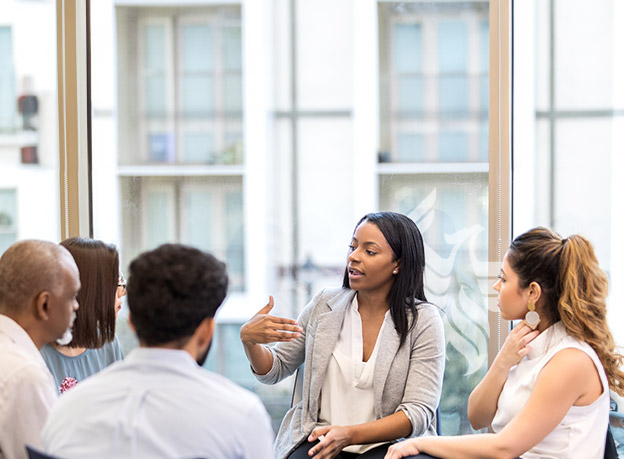 A counselor speaking to a group of people