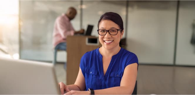 Software developer smiling at the camera in a workplace