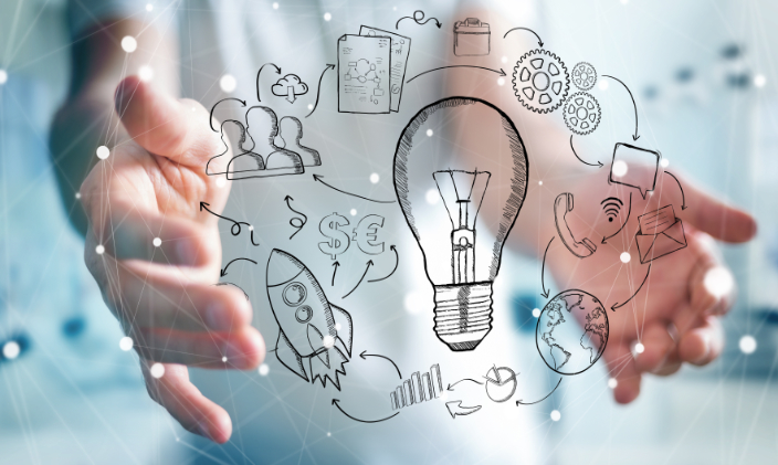 Photo depicting two hands and animated images of light bulb, gears, rocket