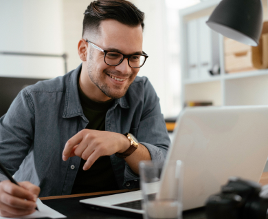 Man with glasses at computer reviewing employee training metrics